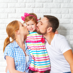 parents kissing child