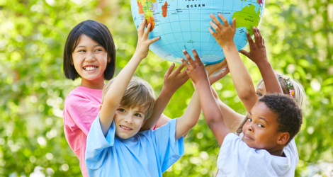 children outdoors carrying globe