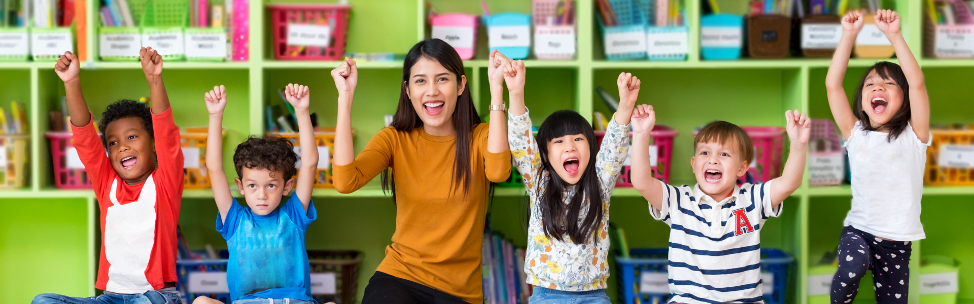 children with young woman raising hands